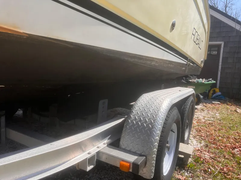 Slide: The Image of 2004 Robalo R225 Walkaround boat on trailer, side view, outdoors. - 47