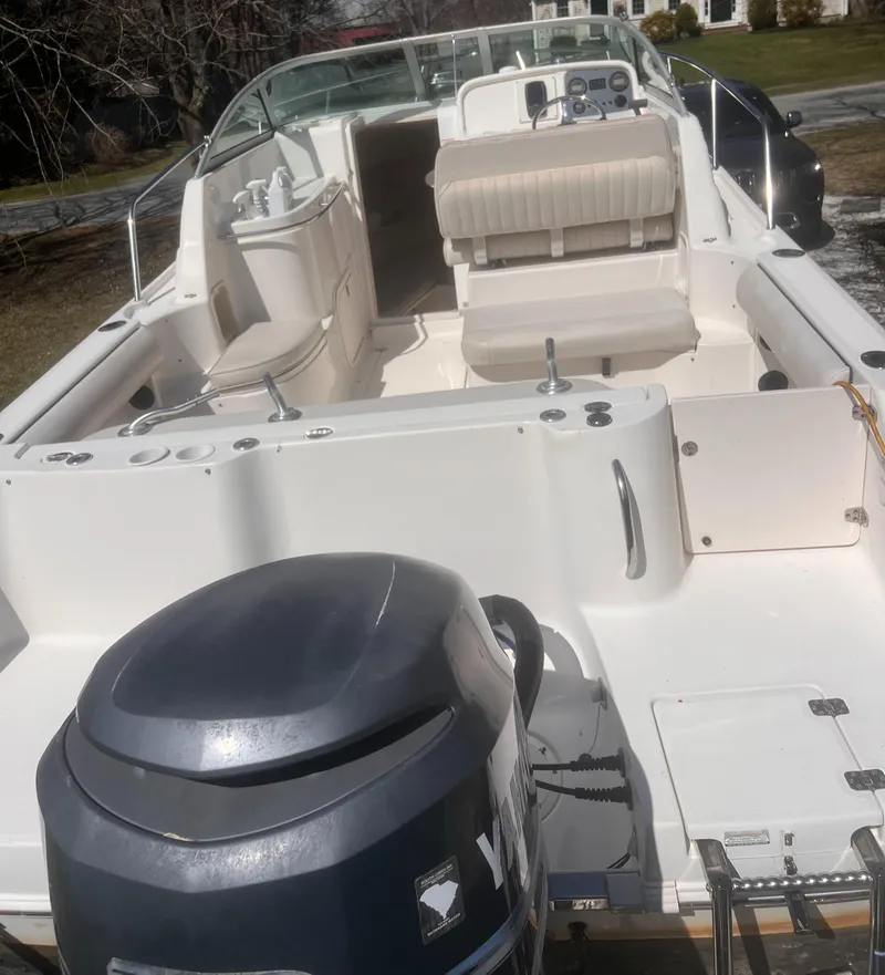 Slide: The Image of 2004 Robalo R225 Walkaround boat with spacious deck and outboard motor. - 9