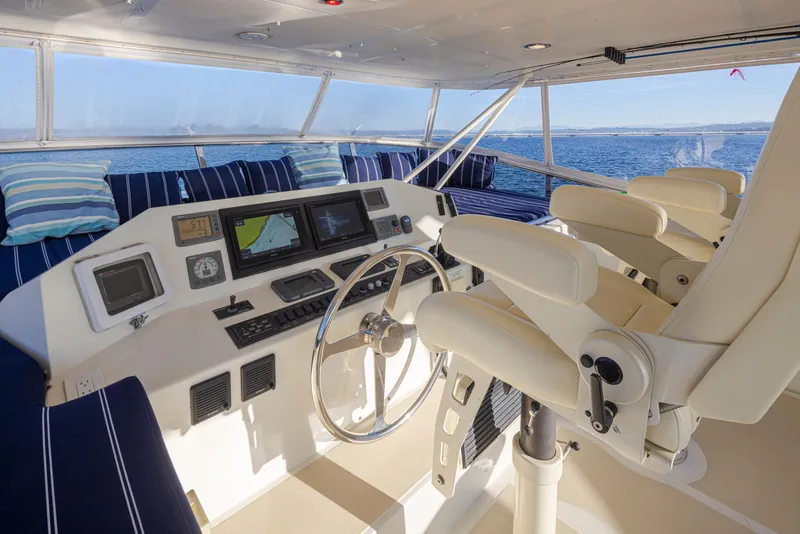 Slide: The Image of Helm of 2003 Marlow 72C yacht with navigation screens and plush seating. - 15
