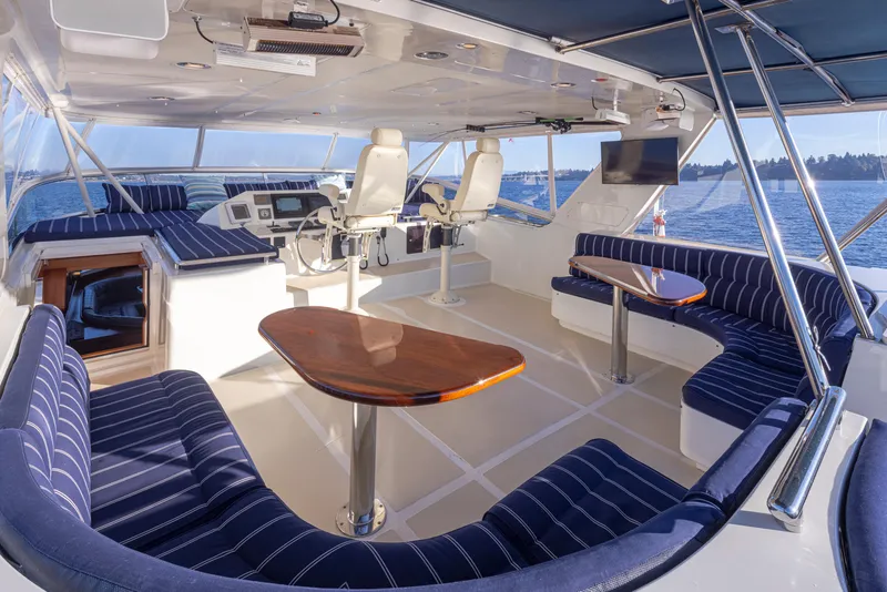 Slide: The Image of Luxurious 2003 Marlow 72C yacht interior with striped seating and ocean view. - 17