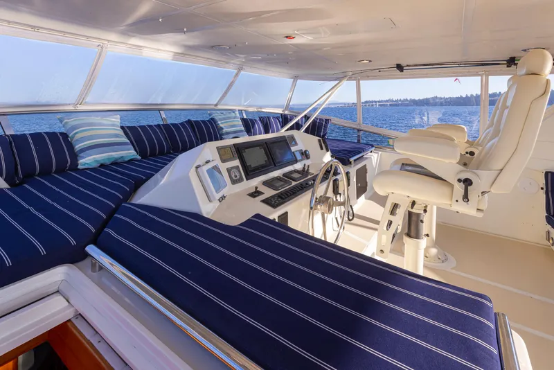 Slide: The Image of Luxurious 2003 Marlow 72C yacht interior with striped seating and navigation controls. - 18