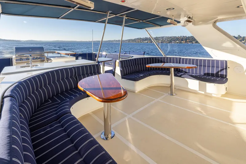 Slide: The Image of Luxurious 2003 Marlow 72C yacht deck with striped seating and ocean view. - 19