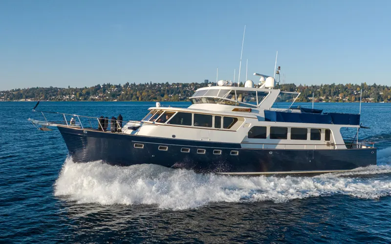 Slide: The Image of 2003 Marlow 72C yacht cruising on open water under clear blue skies. - 2