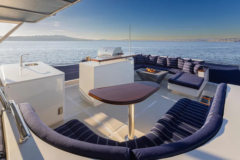 Slide: The Image of Luxurious deck of 2003 Marlow 72C yacht with seating, grill, and ocean view. - 21