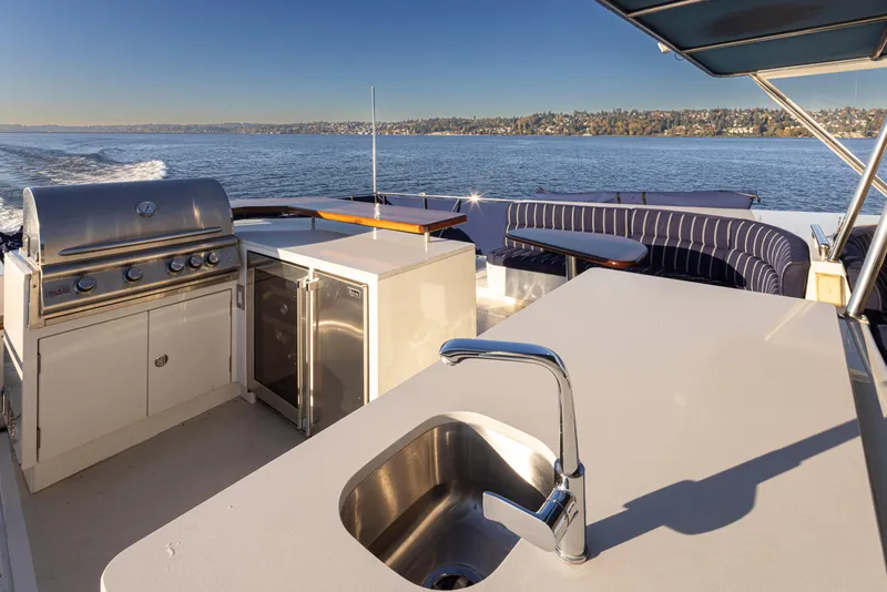 Slide: The Image of Luxury yacht Marlow 72C 2003 with outdoor kitchen and seating area on open water. - 22