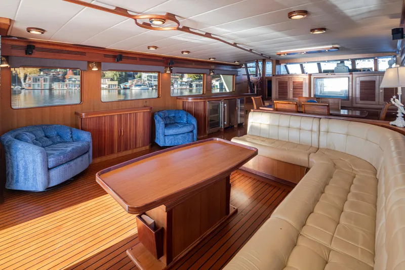 Slide: The Image of Luxurious interior of 2003 Marlow 72C yacht with elegant seating and wooden finishes. - 26