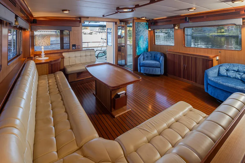 Slide: The Image of Luxurious interior of 2003 Marlow 72C yacht with elegant seating and wooden flooring. - 27