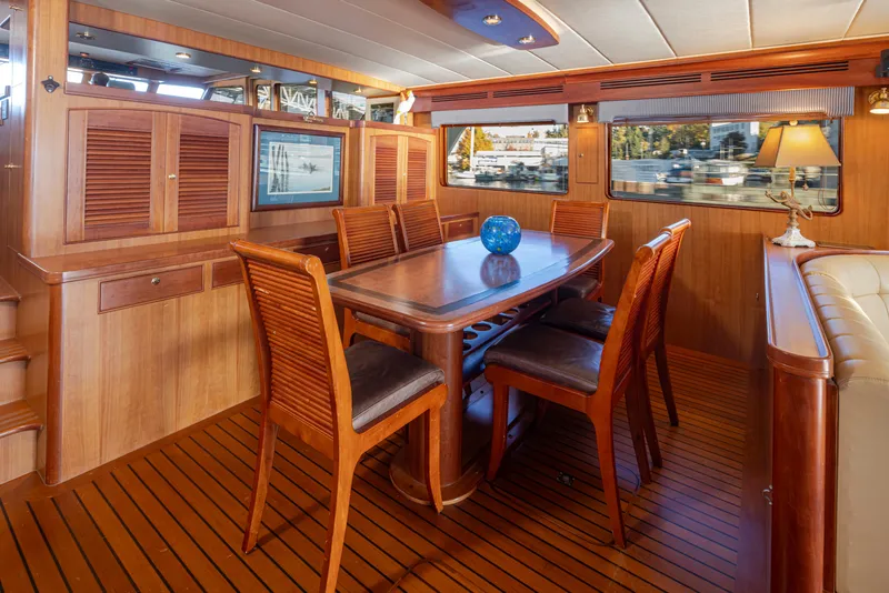 Slide: The Image of Luxurious dining area on 2003 Marlow 72C yacht with elegant wood finish. - 28