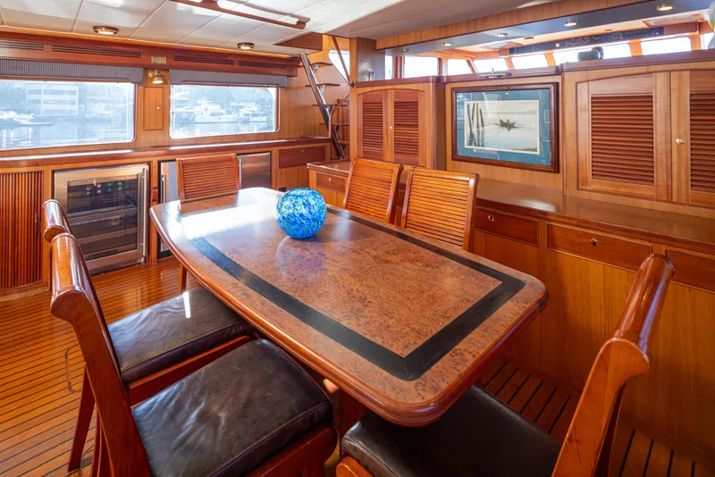Slide: The Image of Luxurious dining area on a 2003 Marlow 72C yacht with elegant wood finishes. - 29