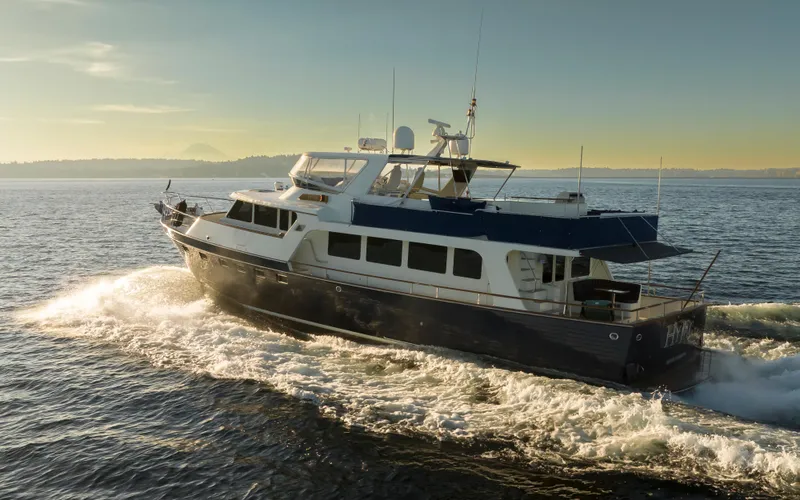 Slide: The Image of Luxurious 2003 Marlow 72C yacht cruising on open water at sunset. - 3