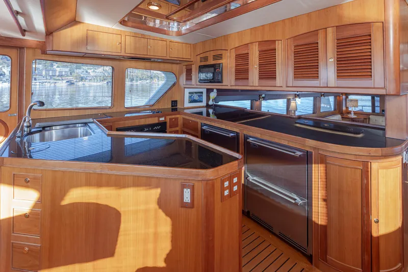 Slide: The Image of Luxurious wooden kitchen interior of 2003 Marlow 72C yacht with modern appliances. - 32