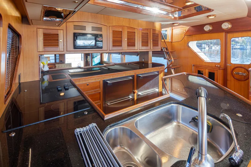 Slide: The Image of Luxurious kitchen interior of 2003 Marlow 72C yacht with modern appliances and wood finish. - 34