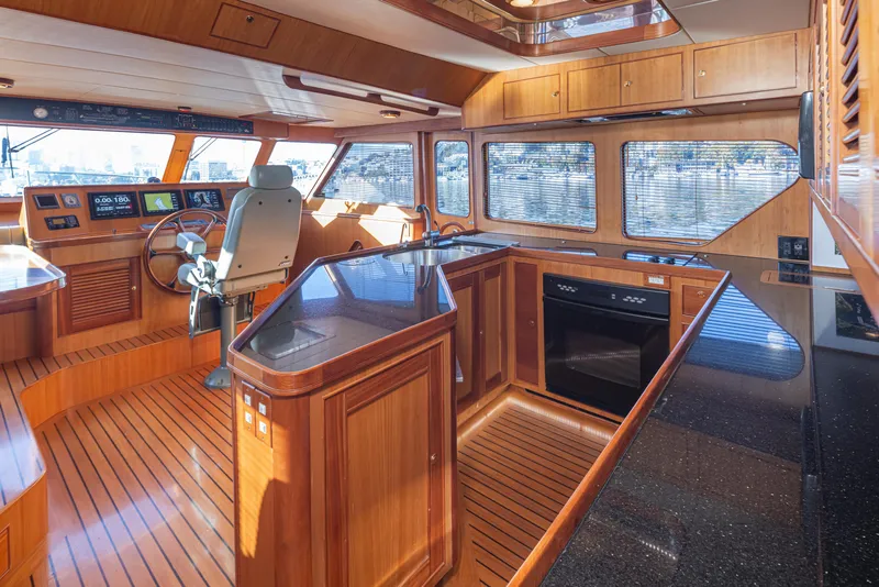 Slide: The Image of Luxurious 2003 Marlow 72C yacht interior with wood finish and modern navigation equipment. - 35
