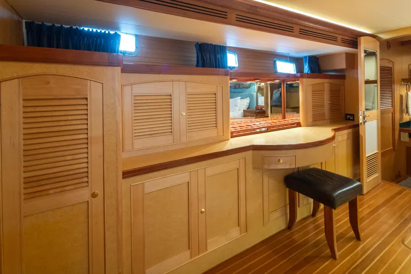 Slide: The Image of Luxurious wooden interior of a 2003 Marlow 72C yacht with elegant cabinetry and seating. - 39
