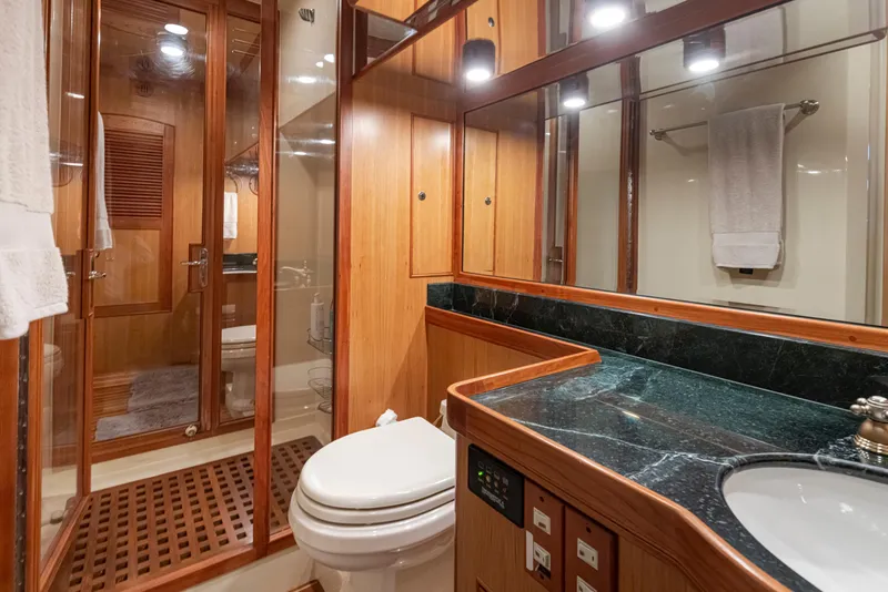 Slide: The Image of Luxurious Marlow 72C 2003 yacht bathroom with wood accents and marble countertop. - 44