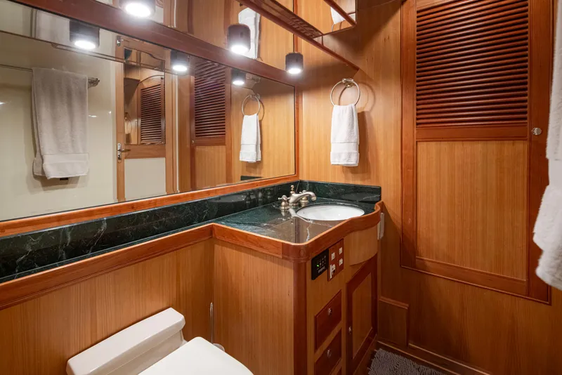 Slide: The Image of Luxurious Marlow 72C 2003 yacht bathroom with wood paneling and elegant fixtures. - 45