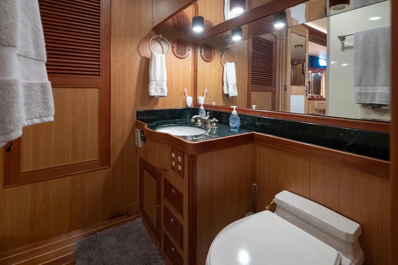 Slide: The Image of Luxurious Marlow 72C 2003 yacht bathroom with wood paneling and elegant fixtures. - 46