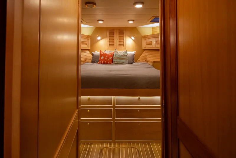 Slide: The Image of Luxurious cabin interior of 2003 Marlow 72C yacht with cozy bedding and warm lighting. - 48