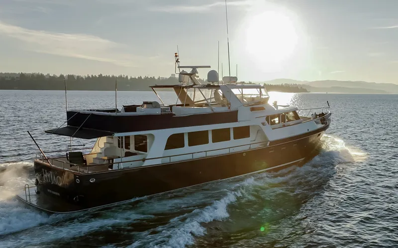 Slide: The Image of Luxurious 2003 Marlow 72C yacht cruising on serene waters at sunset. - 5