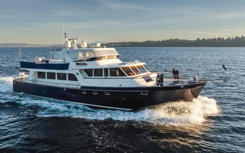 Slide: The Image of Luxurious 2003 Marlow 72C yacht cruising on open water at sunset. - 7