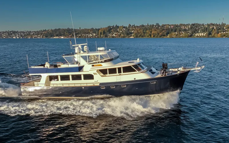 Slide: The Image of Luxurious 2003 Marlow 72C yacht cruising on a serene blue lake. - 8