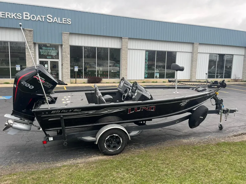 Slide: The Image of 2019 Lund 1875 Pro-V Bass XS boat on trailer outside dealership. - 1