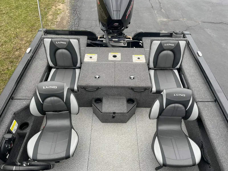 Slide: The Image of 2019 Lund 1875 Pro-V Bass XS boat interior with four seats and fishing rod holders. - 12