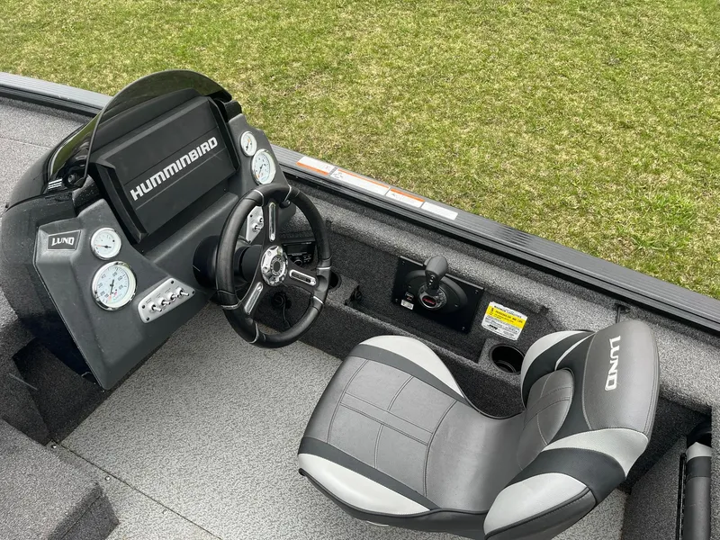 Slide: The Image of 2019 Lund 1875 Pro-V Bass XS boat cockpit with Humminbird electronics and comfortable seating. - 13