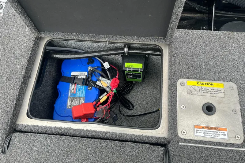 Slide: The Image of 2019 Lund 1875 Pro-V Bass XS battery compartment with wiring and caution labels. - 22