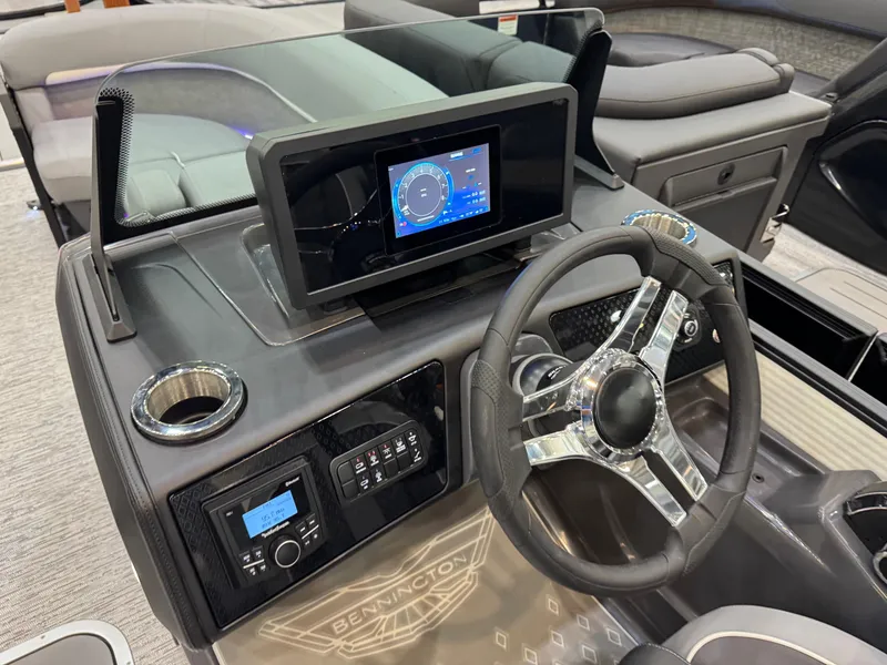 Slide: The Image of 2025 Bennington 22 MFB boat dashboard with modern steering and digital display. - 14