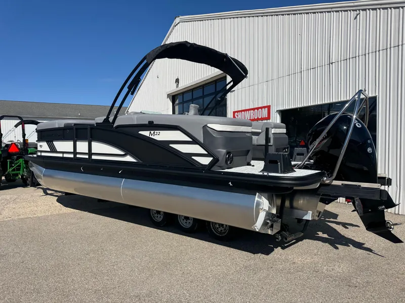 Slide: The Image of 2025 Bennington 22 MFB pontoon boat displayed outside a showroom. - 3