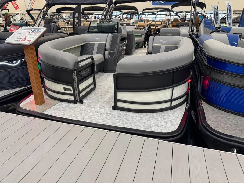 Slide: The Image of 2025 Bennington 22 MFB pontoon boat with stylish seating at a boat show. - 4
