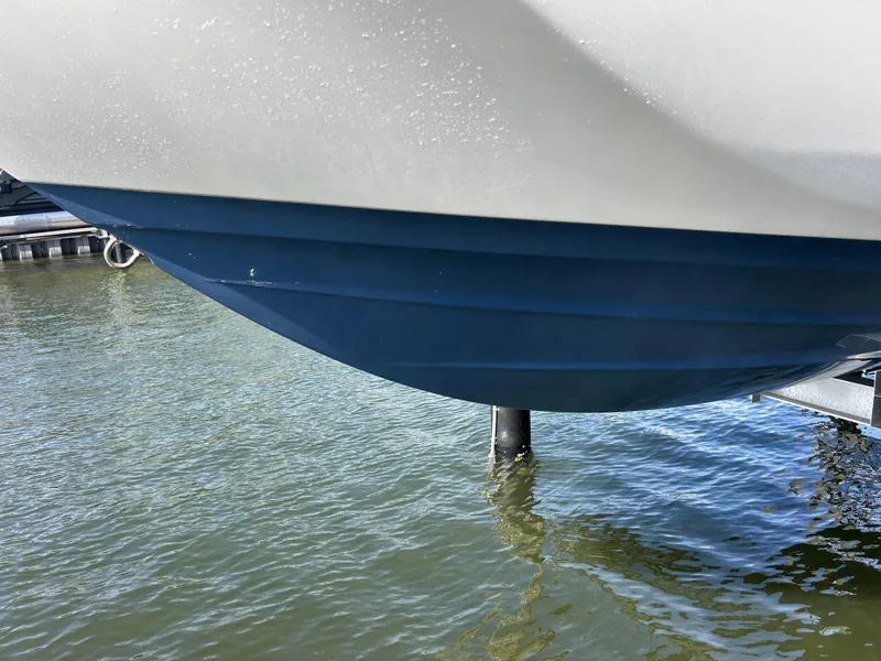 Slide: The Image of 2023 Yamaha Boats 252SD hull above water, showcasing sleek design and craftsmanship. - 11