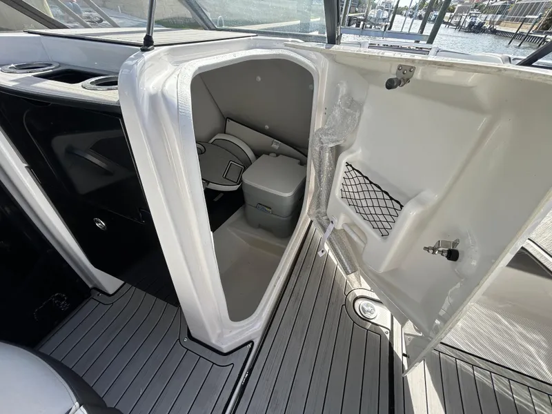 Slide: The Image of 2023 Yamaha Boats 252SD interior with open storage compartment and modern design. - 21