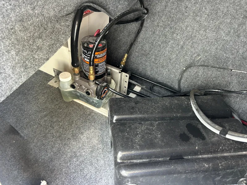 Slide: The Image of 2023 Yamaha Boats 252SD engine compartment with hydraulic components and wiring. - 26