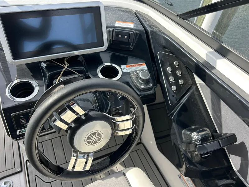 Slide: The Image of 2023 Yamaha Boats 252SD dashboard with steering wheel, touchscreen, and controls. - 27