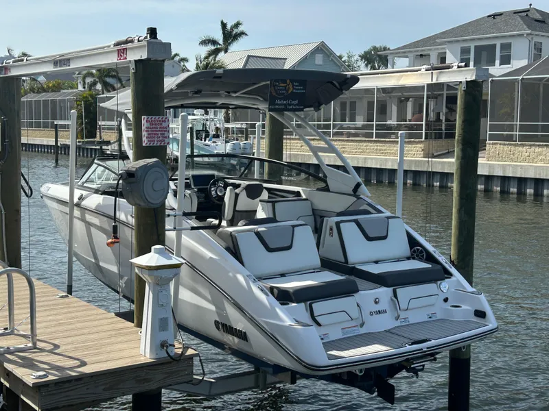 Slide: The Image of 2023 Yamaha Boats 252SD docked, showcasing sleek design and modern features. - 3