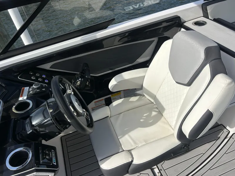 Slide: The Image of 2023 Yamaha Boats 252SD cockpit with modern steering and comfortable seating. - 31