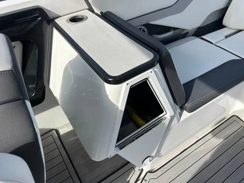 Slide: The Image of 2023 Yamaha Boats 252SD interior with storage compartment and seating. - 33