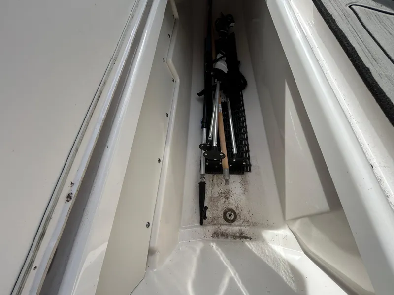 Slide: The Image of Storage compartment in 2023 Yamaha Boats 252SD, holding equipment. - 38