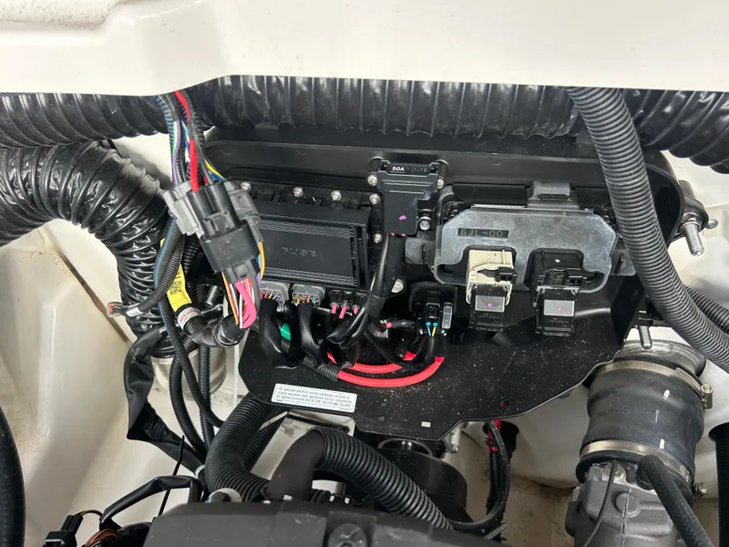 Slide: The Image of Engine compartment of a 2023 Yamaha Boats 252SD, showcasing wiring and components. - 43