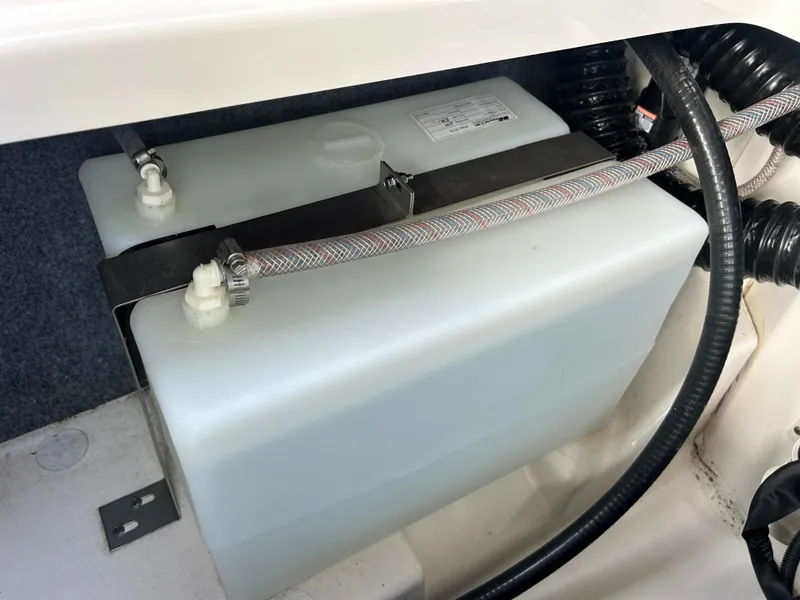 Slide: The Image of 2023 Yamaha Boats 252SD water tank system with hoses and secure fittings. - 44