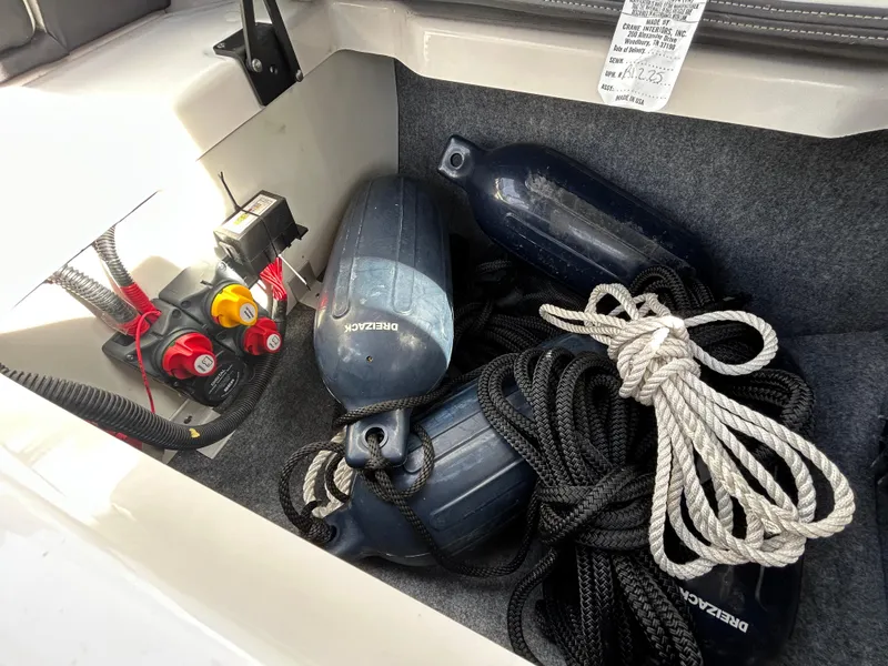 Slide: The Image of Storage compartment of 2023 Yamaha Boats 252SD with fenders and ropes. - 47