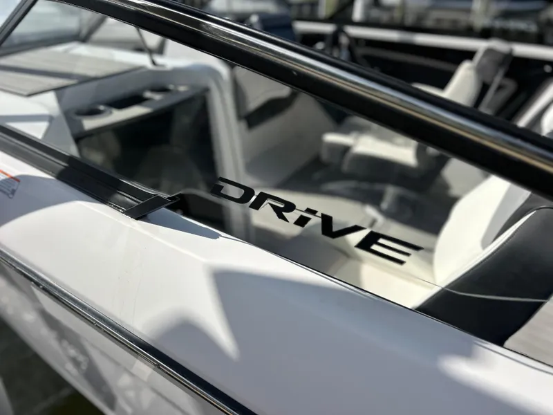 Slide: The Image of 2023 Yamaha Boats 252SD interior with "Drive" logo on sleek design. - 9