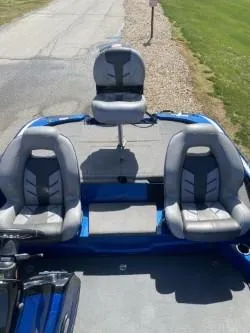 Slide: The Image of 2019 Nitro Z18 boat with three gray seats on a sunny day. - 2