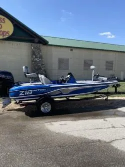 Slide: The Image of 2019 Nitro Z18 boat with blue and white design parked outside a building. - 7