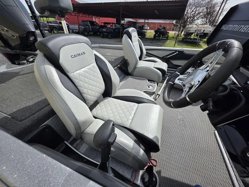 Slide: The Image of 2021 Caymas CX 21 boat interior with premium seating and steering wheel. - 10
