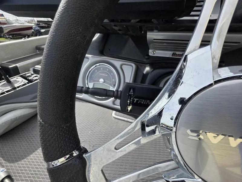 Slide: The Image of Steering wheel and dashboard of 2021 Caymas CX 21 boat, featuring trim control. - 11