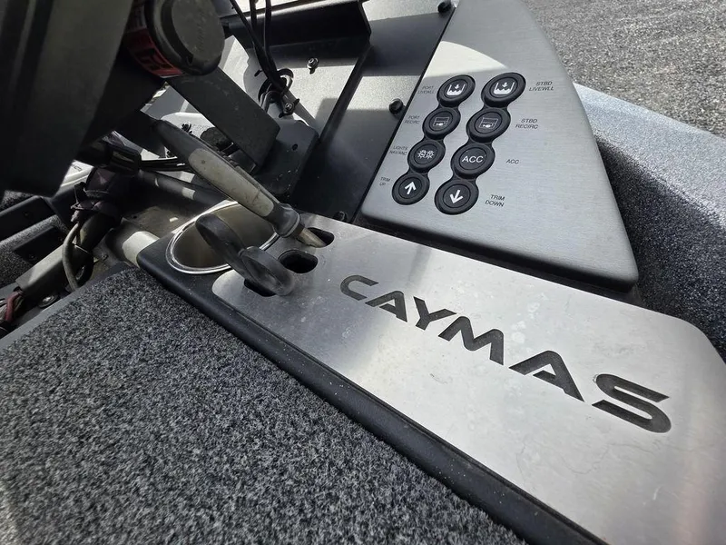 Slide: The Image of 2021 Caymas CX 21 boat dashboard with control panel and branding. - 14
