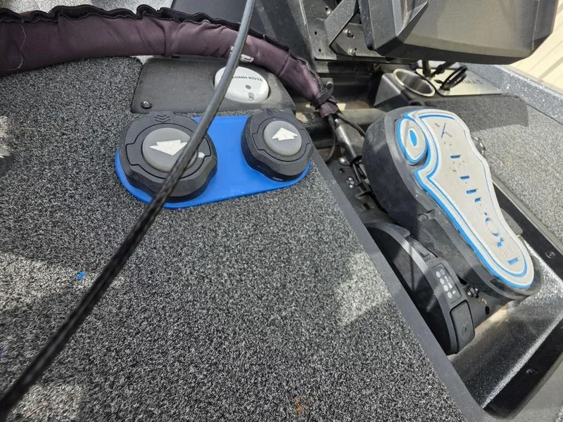 Slide: The Image of 2021 Caymas CX 21 boat dashboard with control panel and motor components. - 17